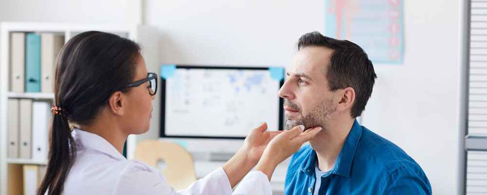 ENT doctor checking patient's throat