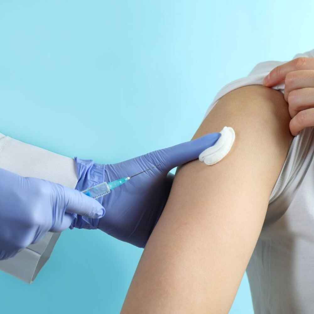 Doctor injecting allergy shot into patient
