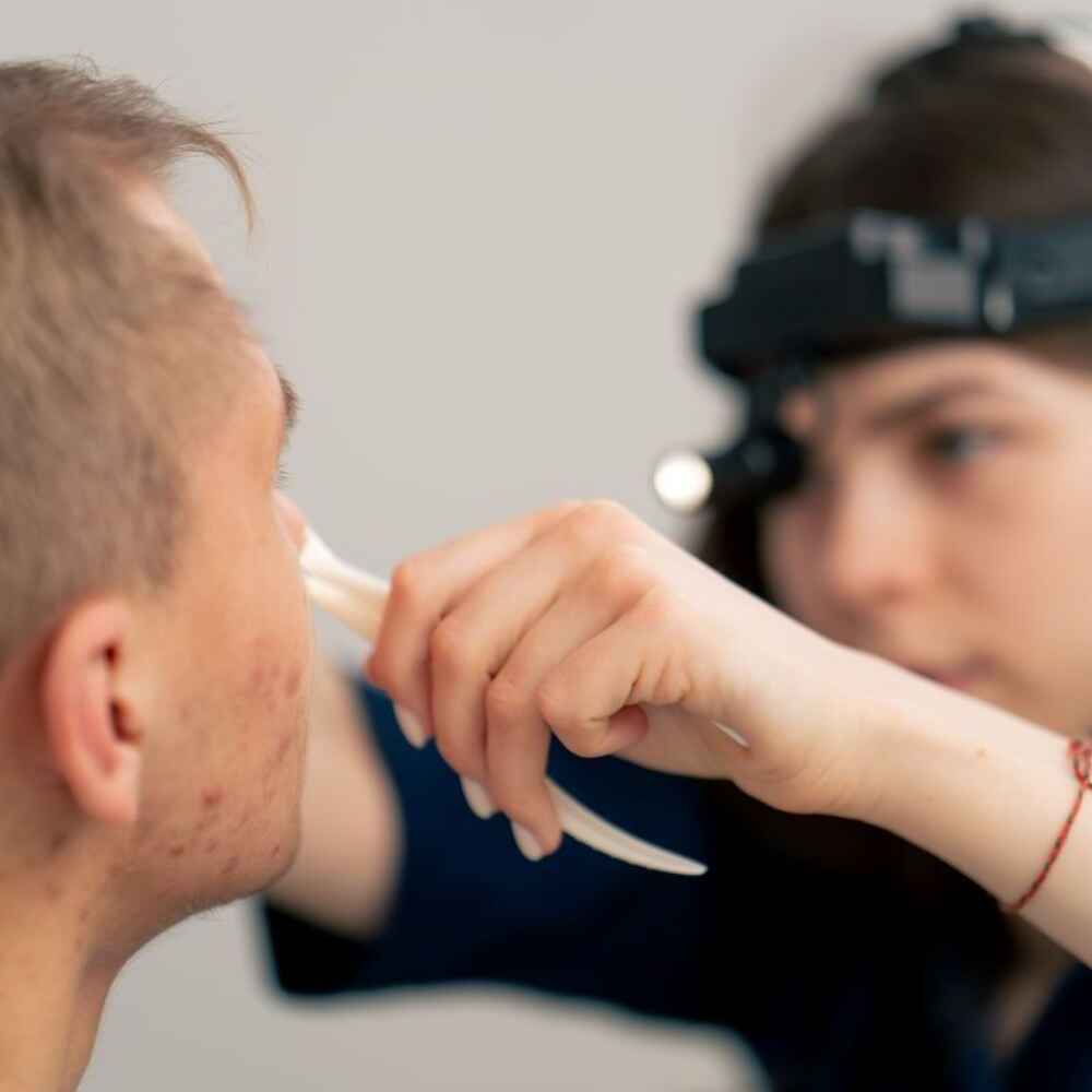 ENT doctor examining patient's nose