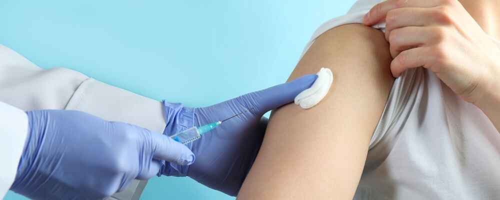 Doctor injecting allergy shot into patient