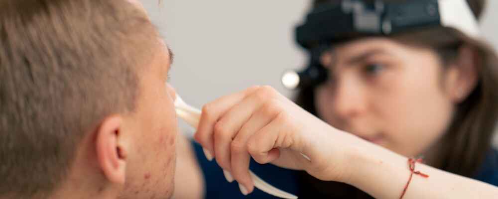 ENT doctor examining patient's nose